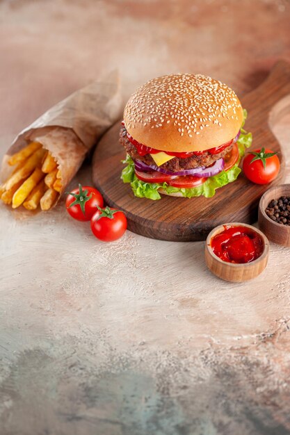 Front view yummy meat cheeseburger with french fries on cutting board light background salad dinner snack fast-food sandwich dish burger