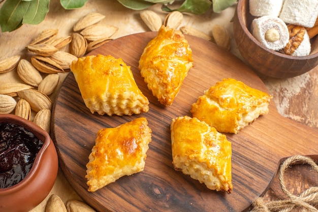 Front view of yummy nut cakes with nuts on wooden surface