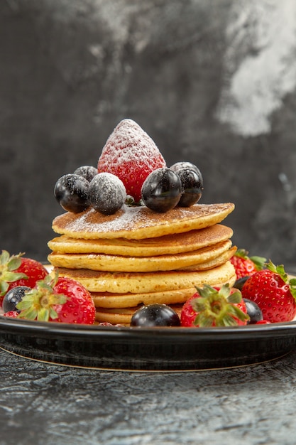 Front view yummy pancakes with fresh fruits on light surface breakfast sweet fruit