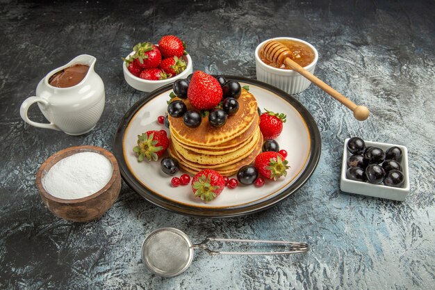 Front view yummy pancakes with fresh fruits on light surface fruit cake sweet