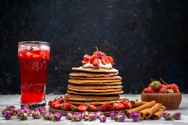 A front view yummy round pancakes with fresh red strawberries cinnamon and strawberry cocktail cake 