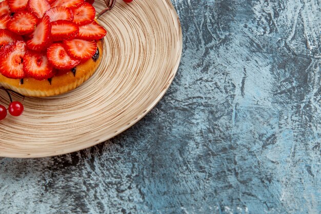 Front view of yummy strawberry cake with red berries on dark surface