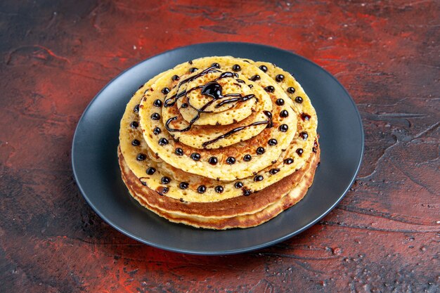 Front view yummy sweet pancakes with icing on dark background