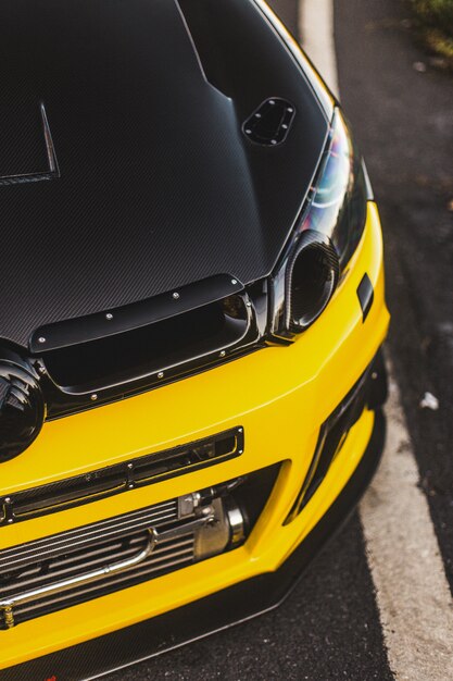 Front xenon lights of a yellow black car. Top view.