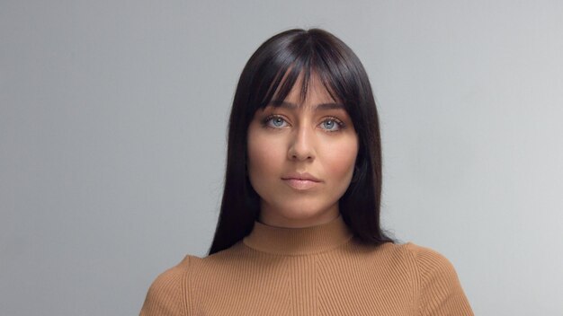 Frontal portrait of mixed race eastern model brunette watching to the camera