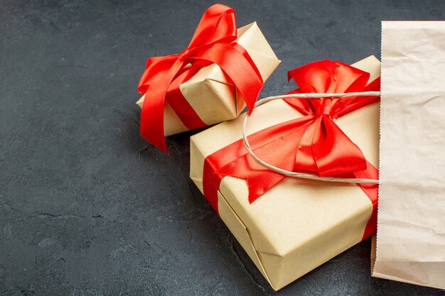 Frontl view of beautiful gifts with red ribbon on a dark table