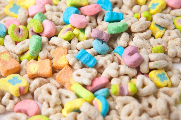 Frosted toasted oat cereal with fun shaped marshmallows on white background.