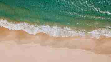 Free photo frothy waves and sandy beach from above