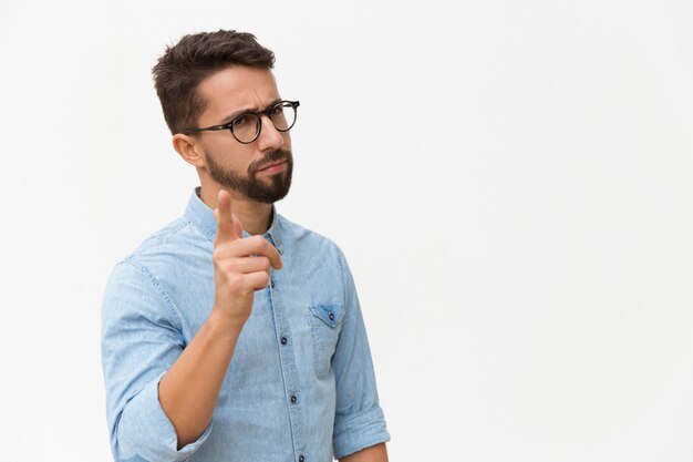 Frowning concerned guy shaking finger