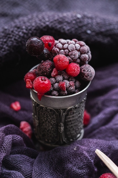 frozen berries in an antique silver cup