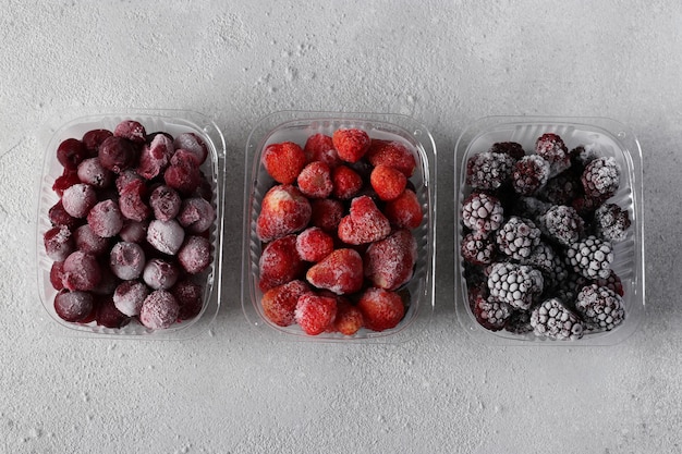 Frozen berries such as strawberries cherries and blackberries in the storage boxes