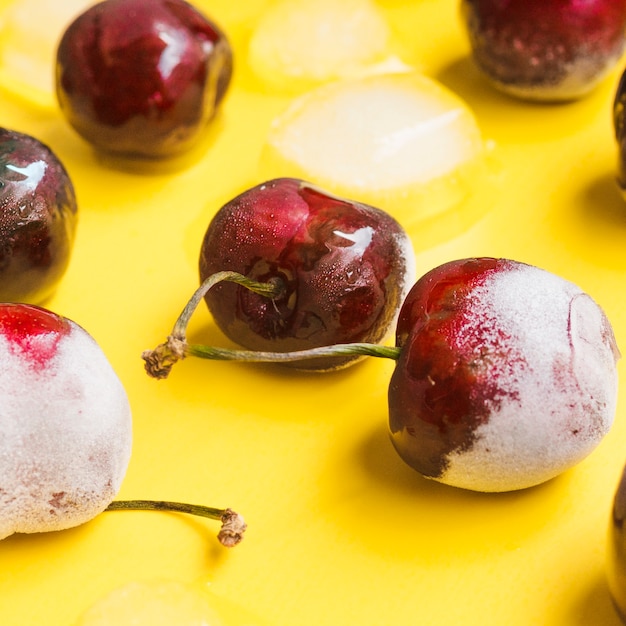 Frozen cherries on yellow background