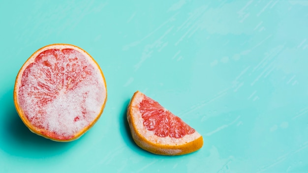 Frozen grapefruit on turquoise background