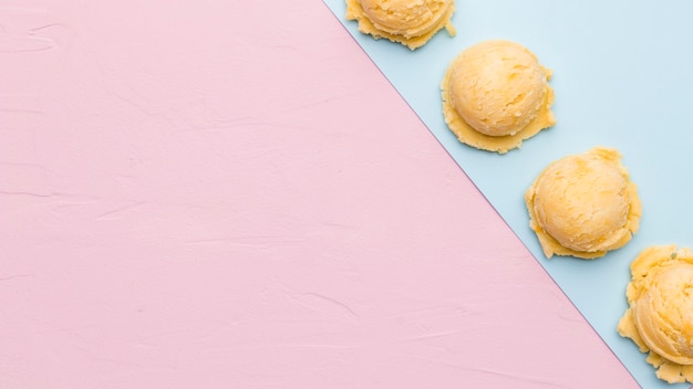 Frozen ice cream scoop on multicolored surface