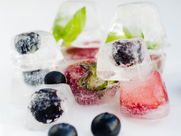 Frozen strawberry and blueberry in ice cubes