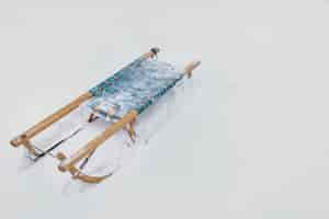 Free photo frozen wooden sledge on snowy land at winter season