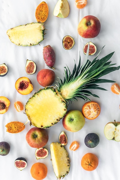 Fruit background with cut pineapple and other exotic fruits