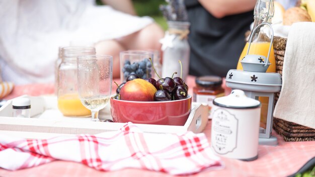 Fruit bowls and beer glass on picnic