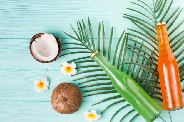 Fruit drinks in bottles and ripe coconuts