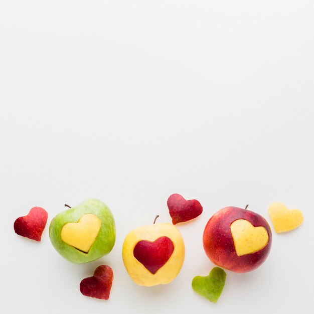 Fruit heart shapes and apples with copy space