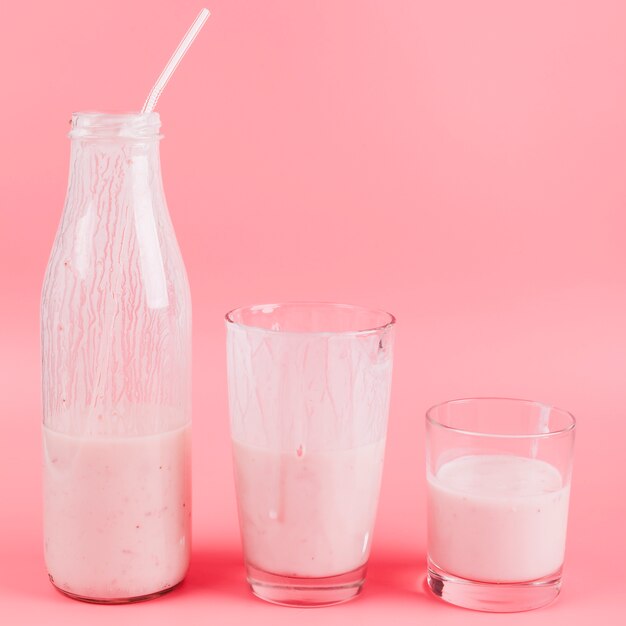 Fruit milkshake on pink background 