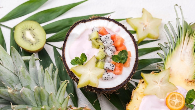 Free photo fruit salad in coconut plate and pineapple stars