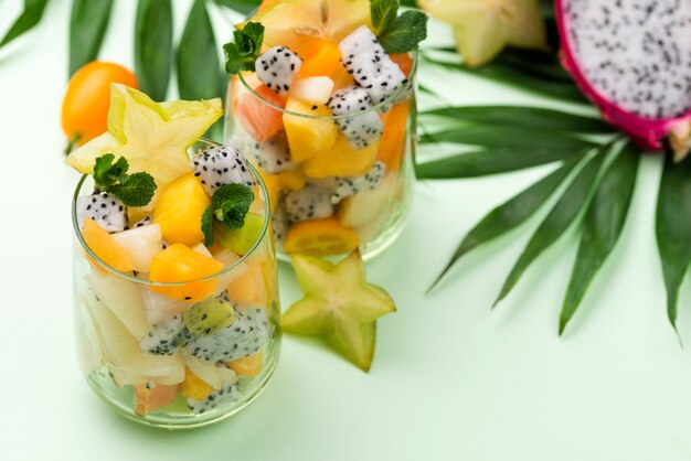 Fruit salad in glass and leaves