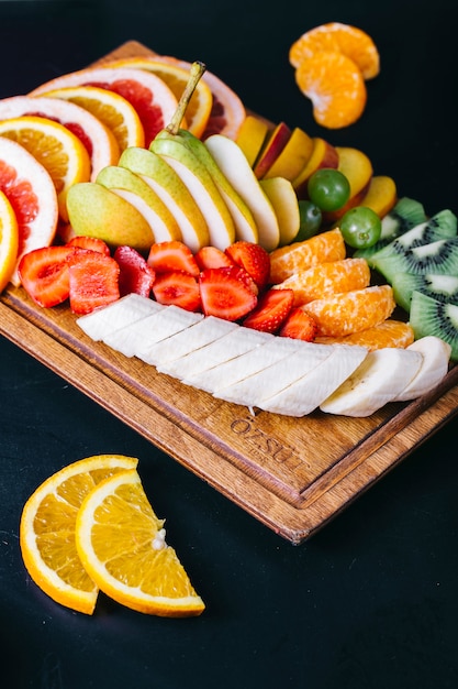 Fruit salad with bananas strawberries mandarins oranges and pears