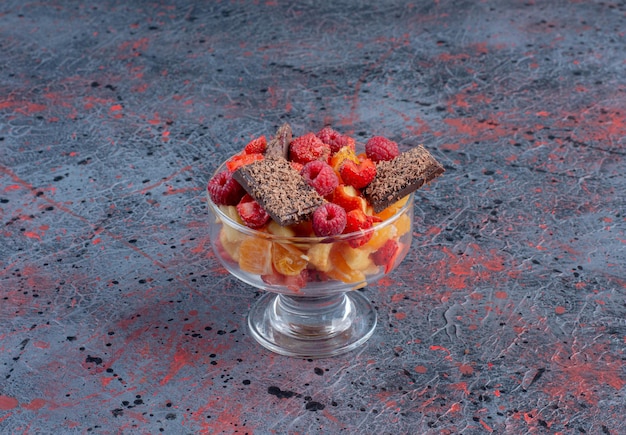 Fruit salad with berries and bitter chocolate. 