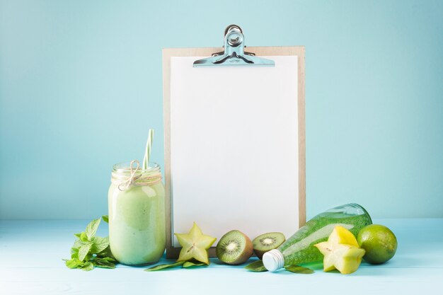 Fruit and smoothie with blank clipboard copyspace