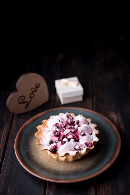 Fruit tart on plate with heart and gift