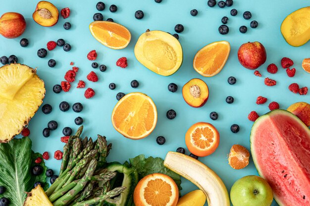 Fruits berries and vegetables on a blue background