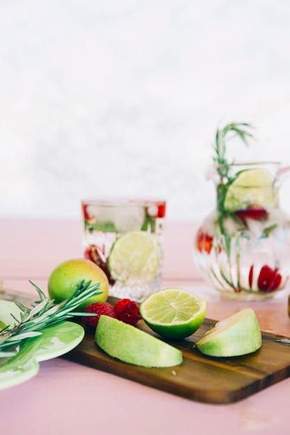 Fruits and berries on wooden chopping board