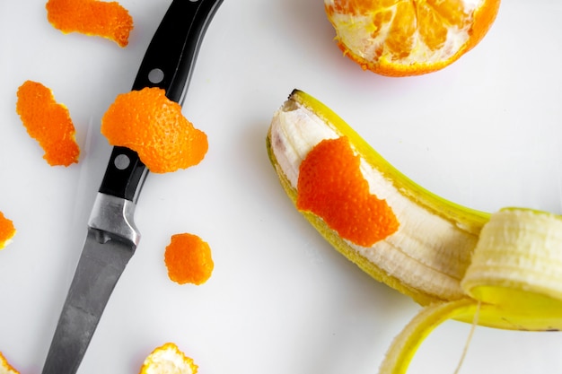 Foto gratuita mandarino e banana sbucciati freschi maturi freschi di frutta