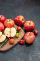 Free photo fruits fruits berries on the board next to the apples