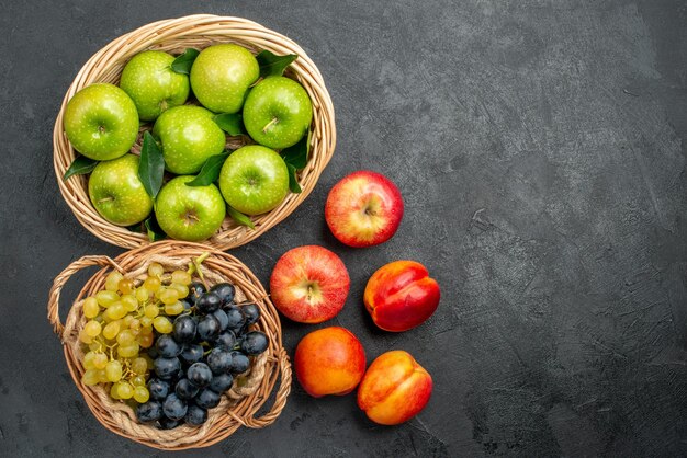 fruits green apples in the basket nectarines and bunches of grapes