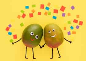 Free photo fruits holding hands with confetii