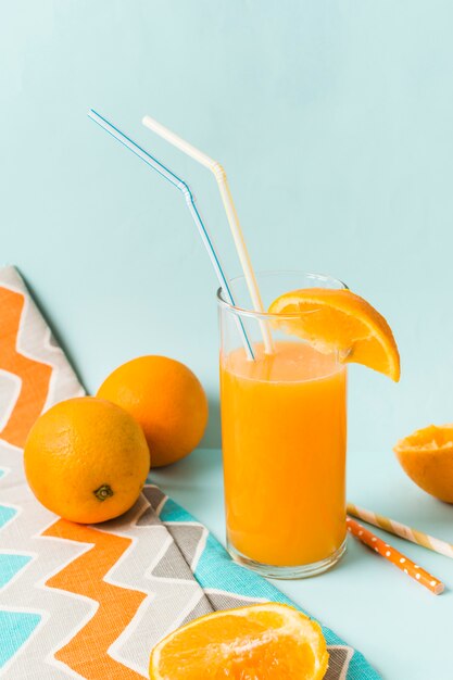 Fruits near glass with juice