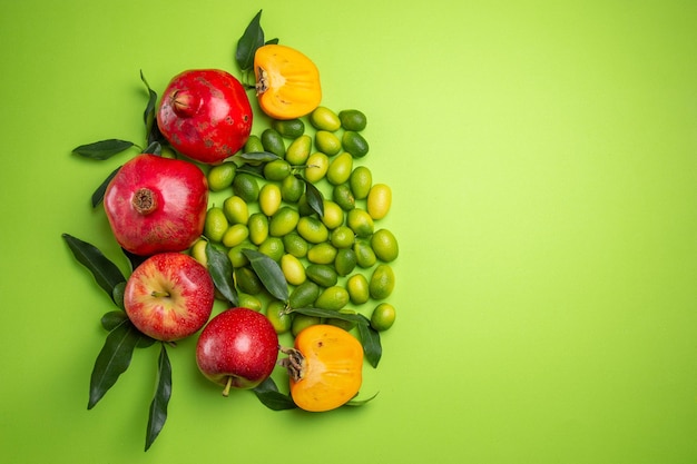 Free photo fruits pomegranates apples citrus fruits persimmons