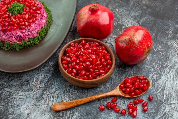 fruits seeds of pomegranate spoon an appetizing dish