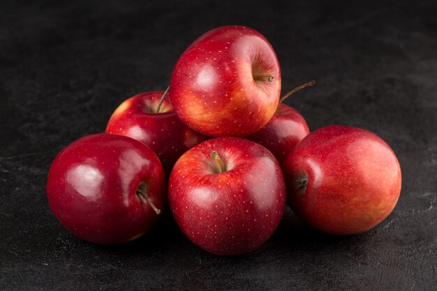 Fruits several fresh ripe red apples on grey desk