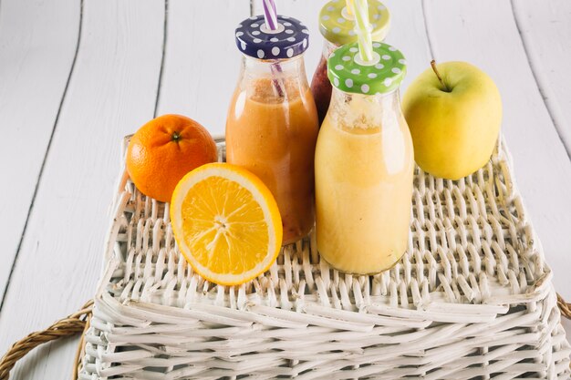 Free photo fruits and smoothie on basket