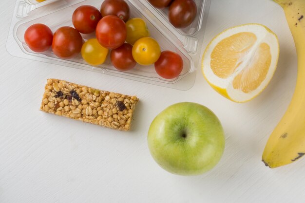 Fruits and tomatoes on white