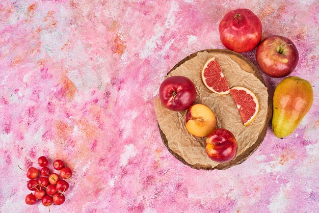 Fruits on wooden platter.