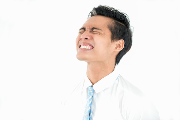 Frustrated Asian businessman with closed eyes