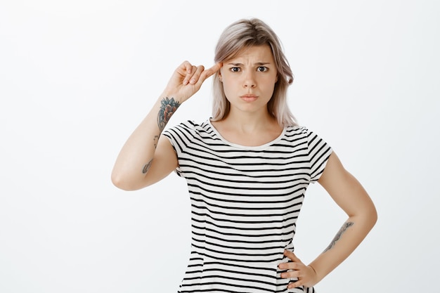 Frustrated blonde girl posing in the studio