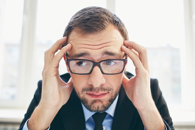 Frustrated businessman with glasses