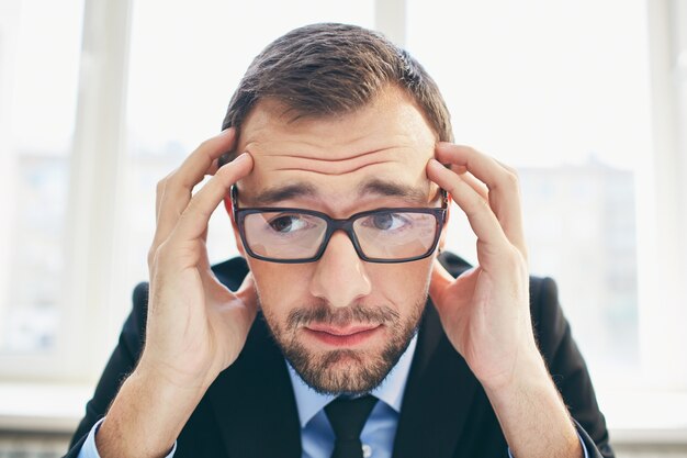 Frustrated businessman with glasses