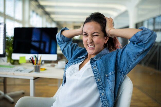 Frustrated female graphic designer in office