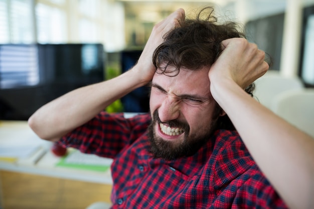 Free photo frustrated male graphic designer in office